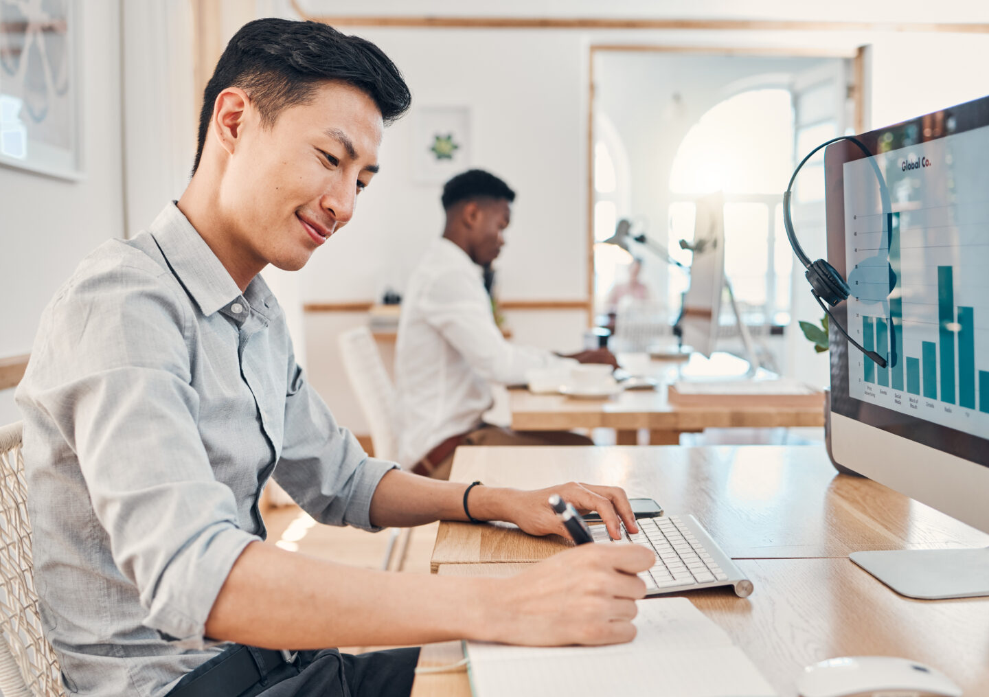 Asian businessman, computer data and writing in office working on marketing or social media adverti